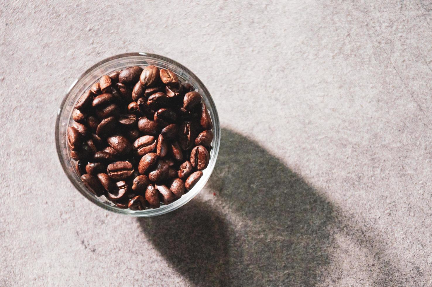 Fresh coffee beans in glass bowl on a background photo