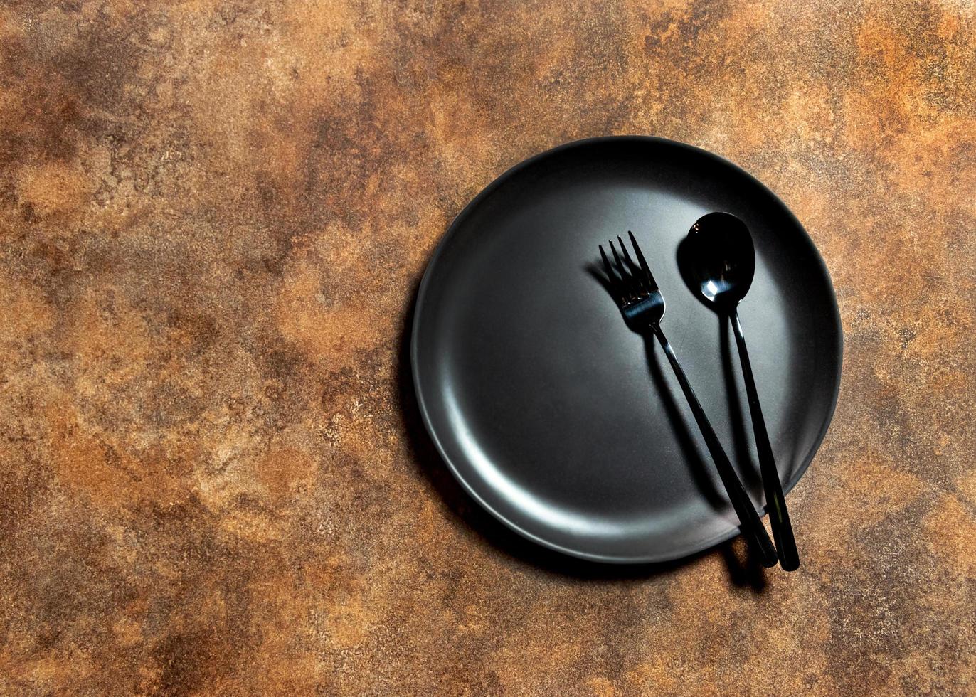 Empty plate with silver fork  and Spoon dining dish, copy space photo