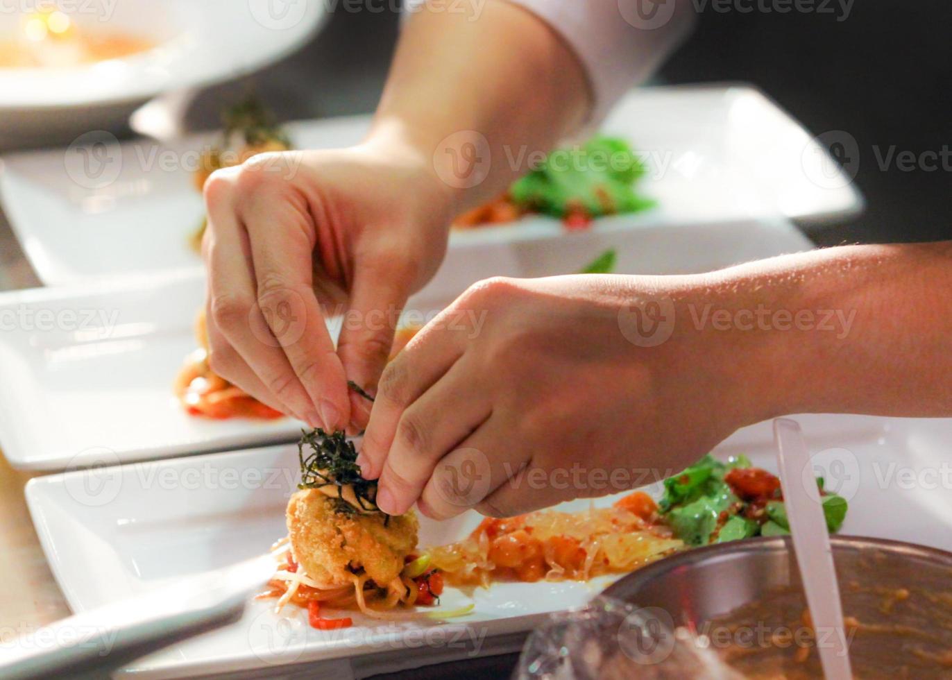 chef cooking, Chef preparing food, Chef decorating dish in the kitchen photo