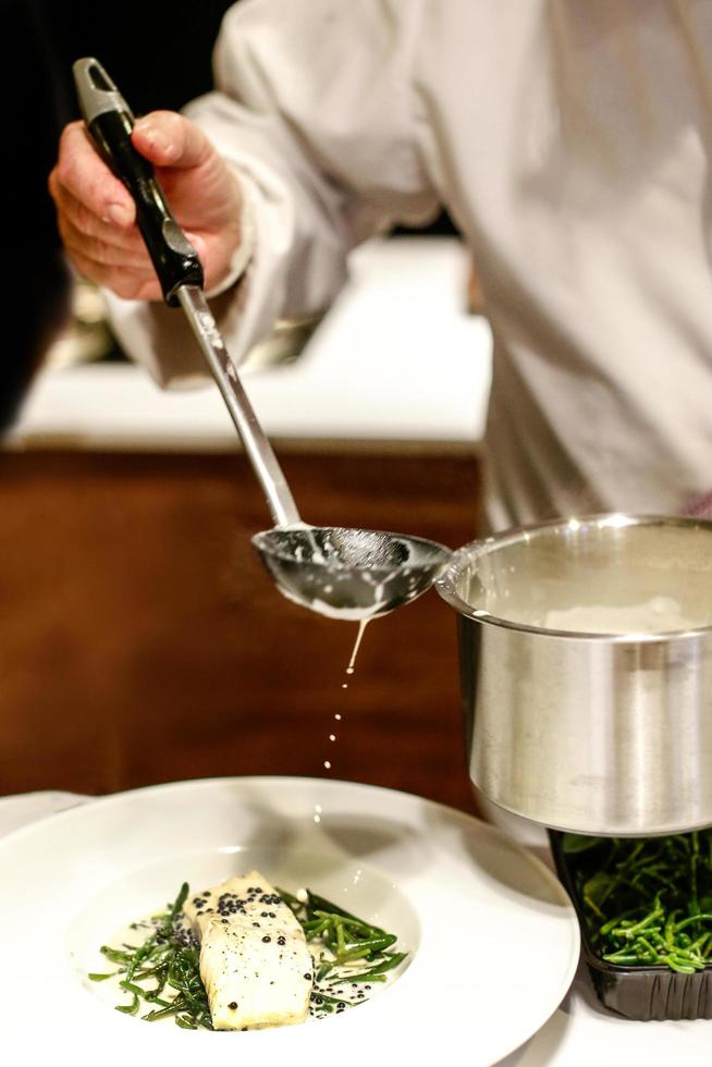 chef cooking, Chef preparing food, Chef decorating dish in the kitchen photo
