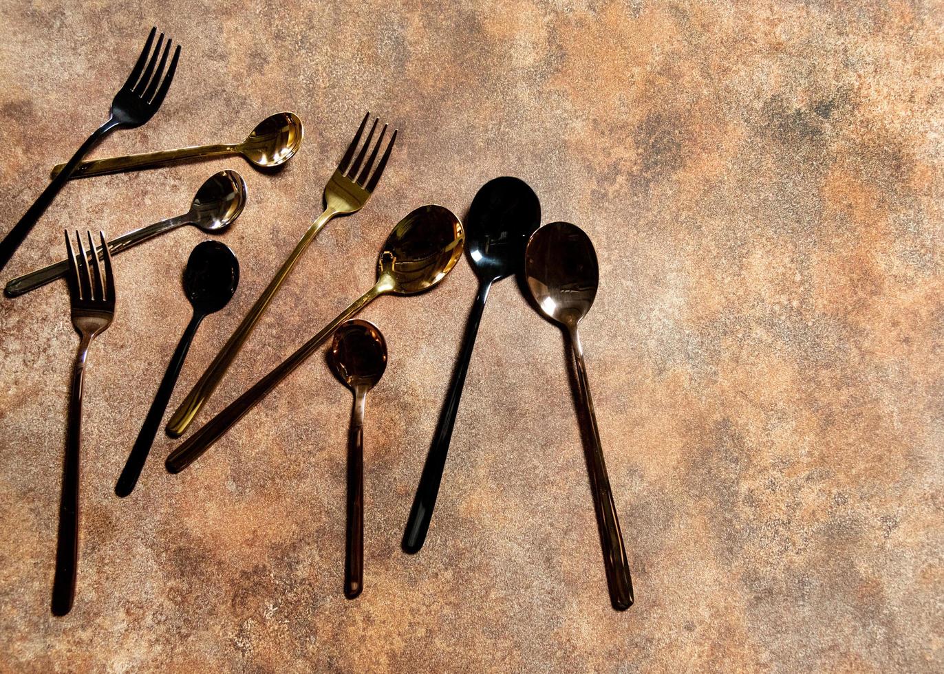 Silver spoon and silver fork at restaurant table photo