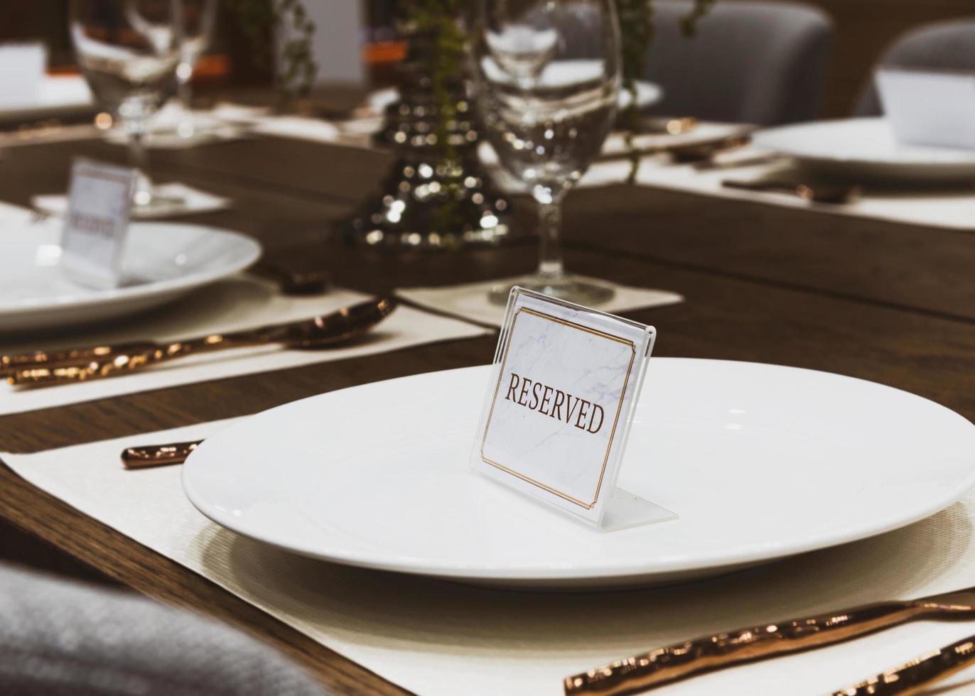 Reservation on a dinner table at the restaurant, plate reserve photo