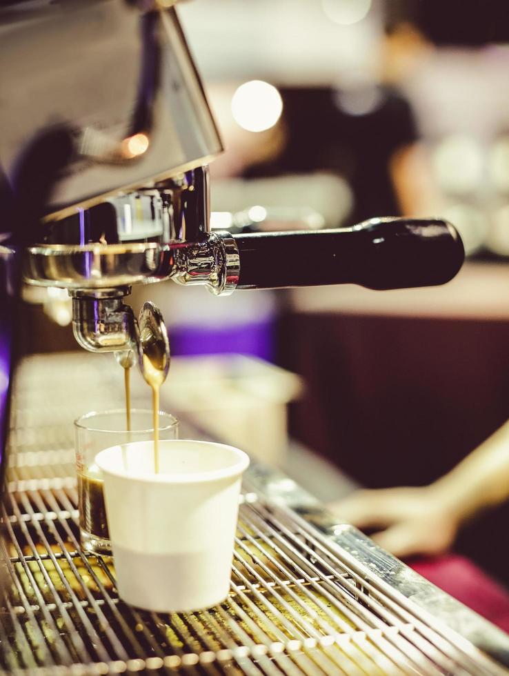 espresso shot from coffee machine in coffee shop photo