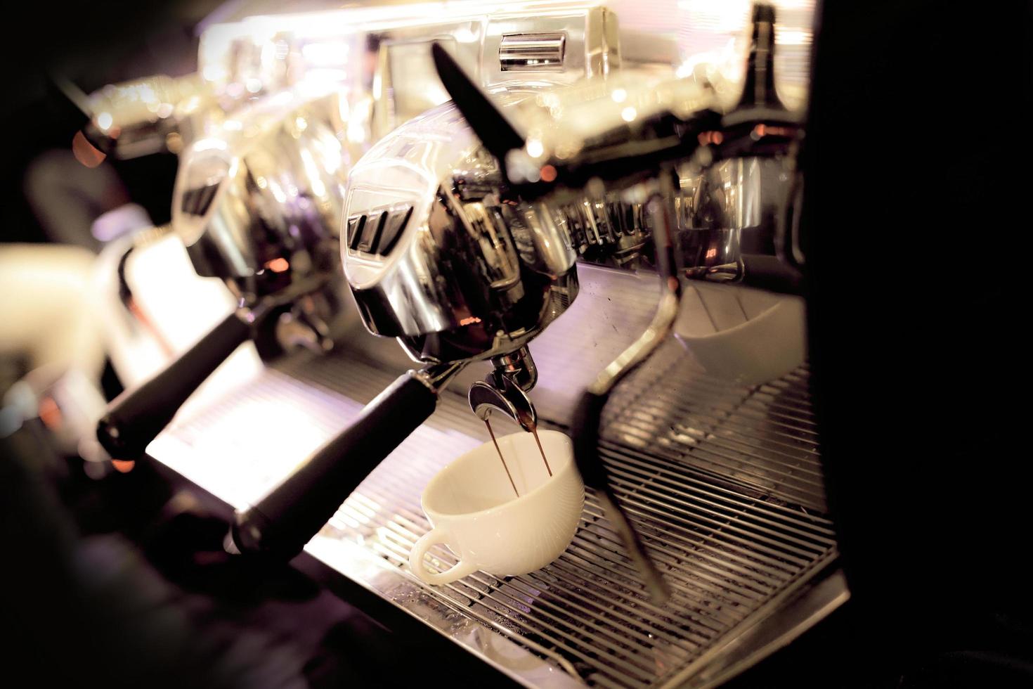 espresso shot from coffee machine in coffee shop photo