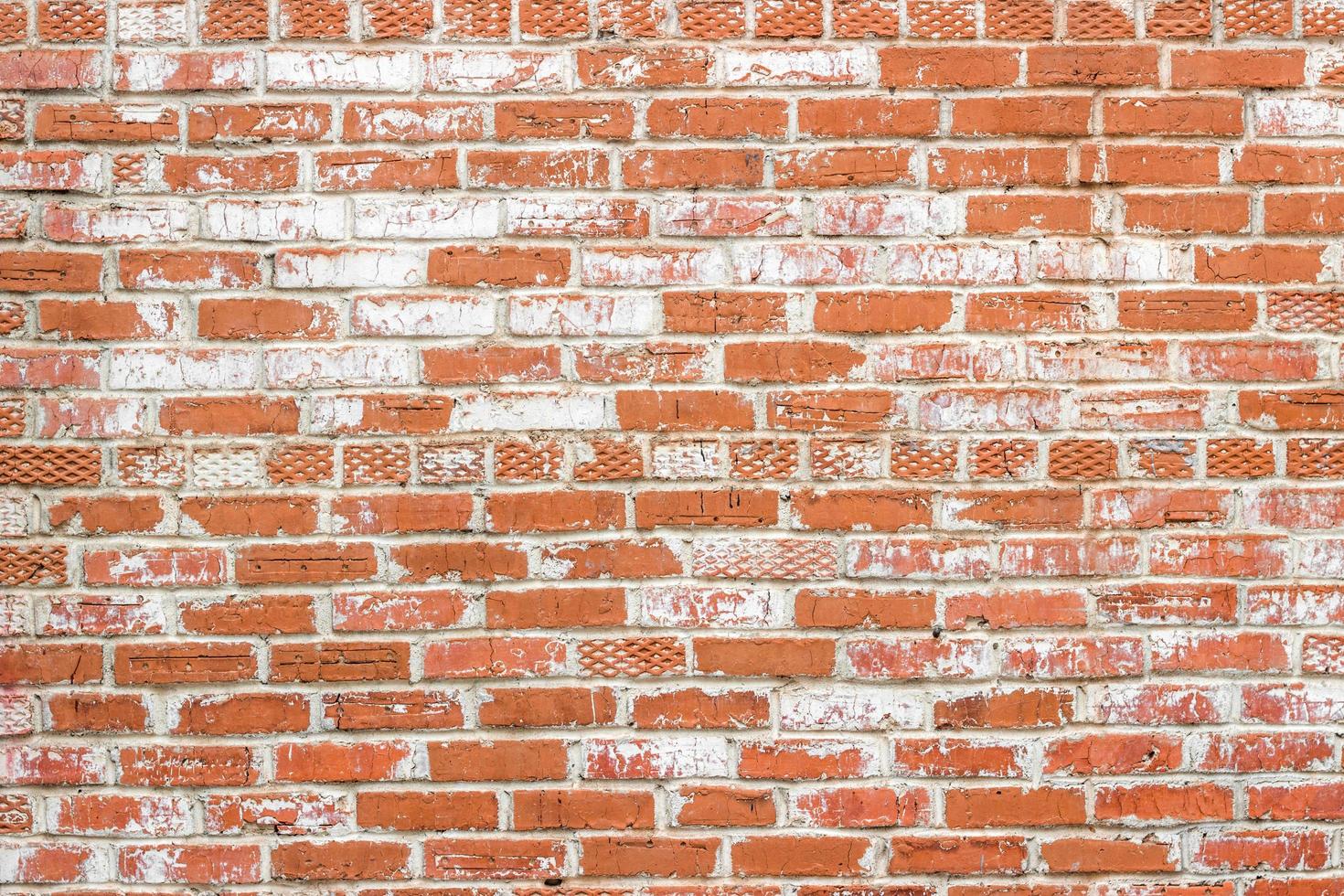 Texture of old brick wall with traces of white paint photo