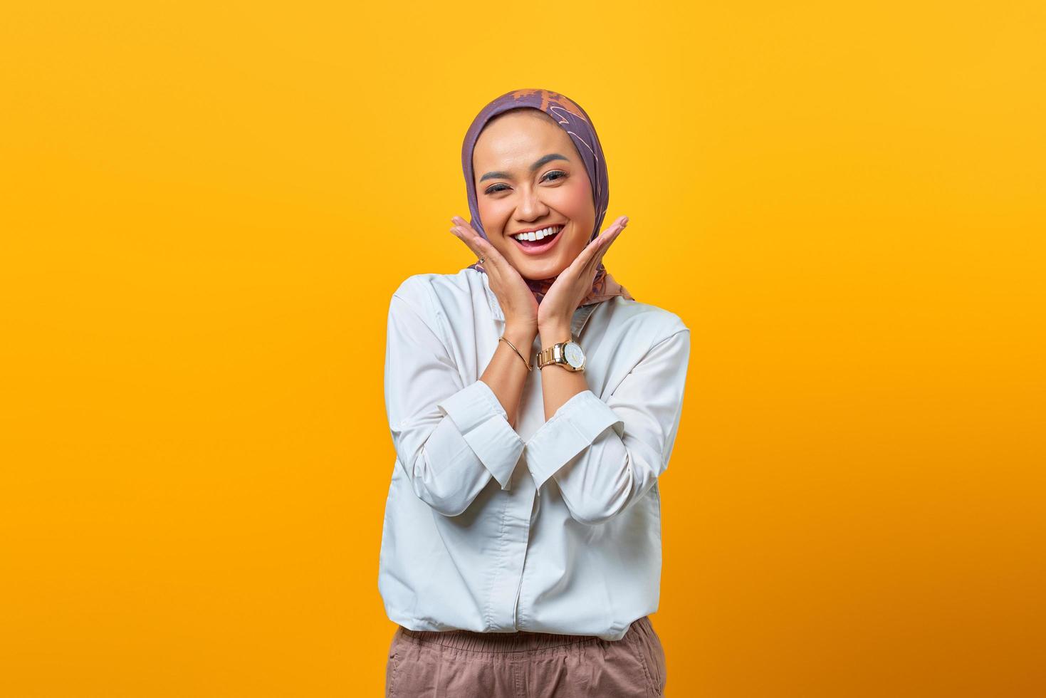 Portrait of cheerful Asian woman hand touch face photo