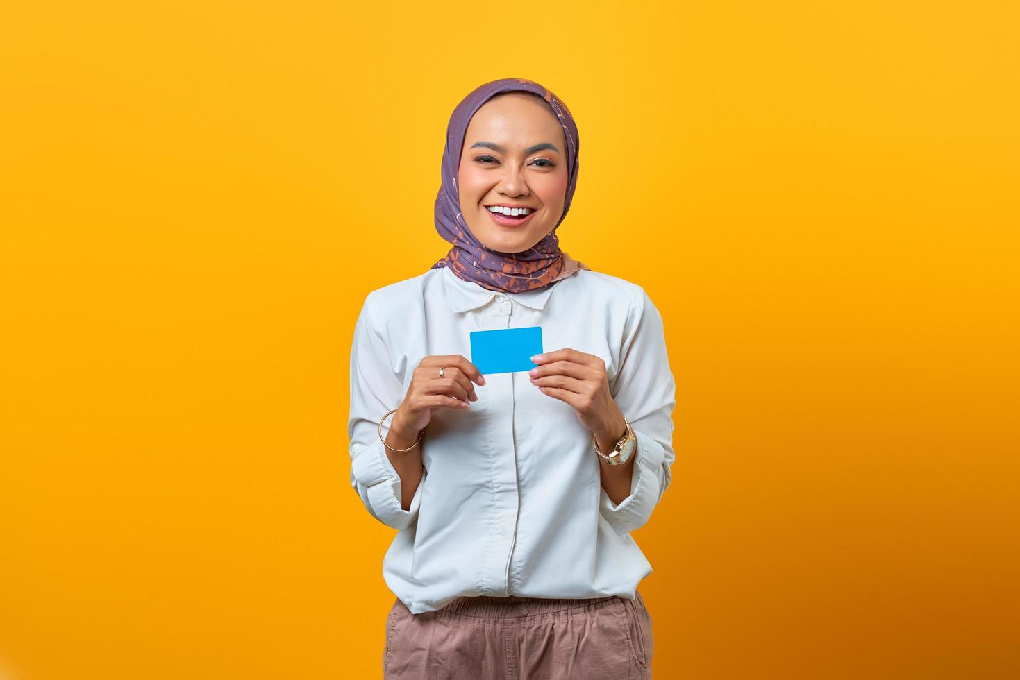 Beautiful Asian woman holding in hand blank card with smiling face photo