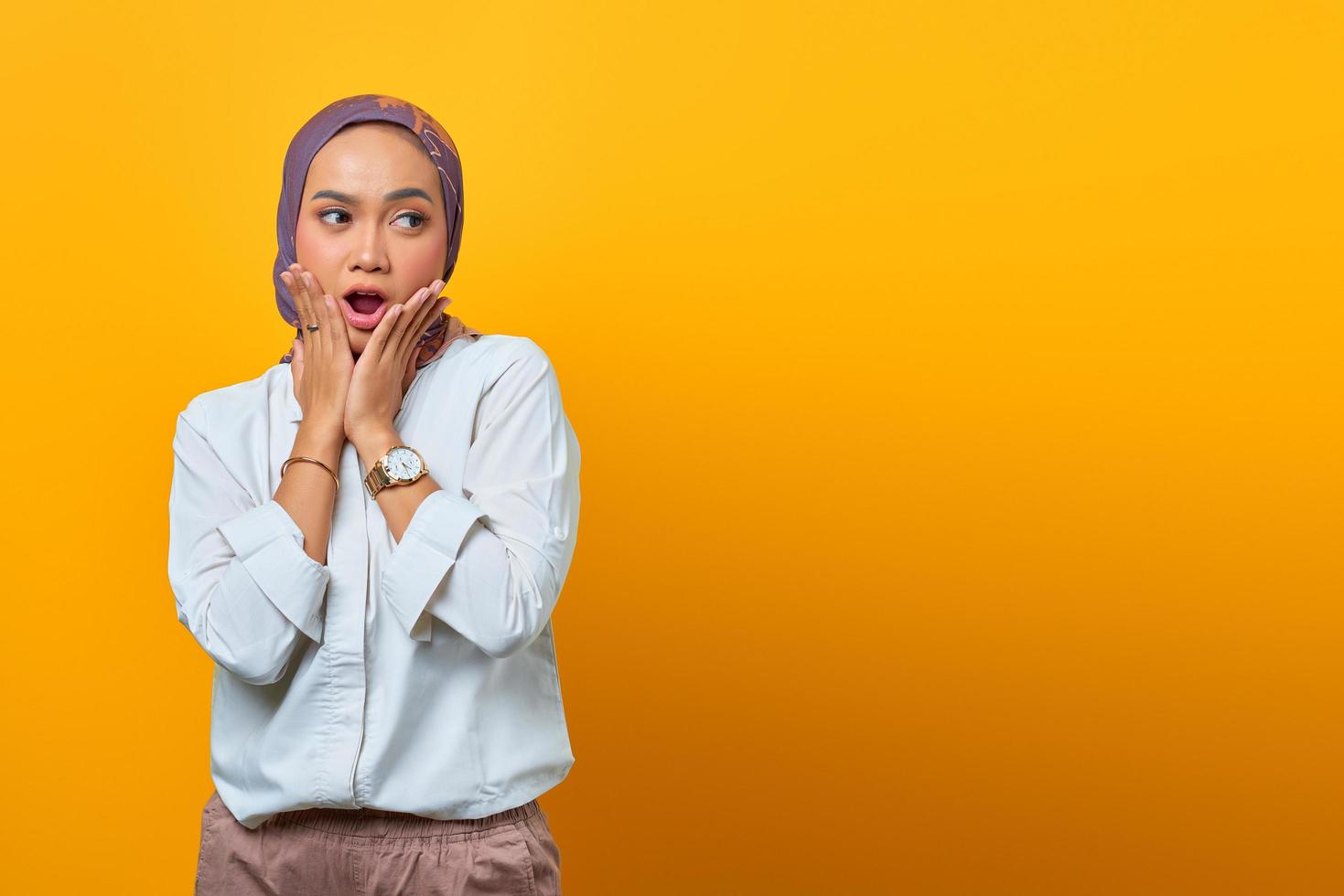 Portrait of shocked Asian woman with open mouth and looking the side photo