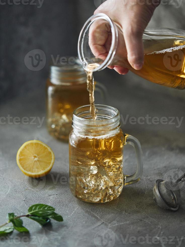 Iced ice tea in the style of minimalism on a gray background. photo