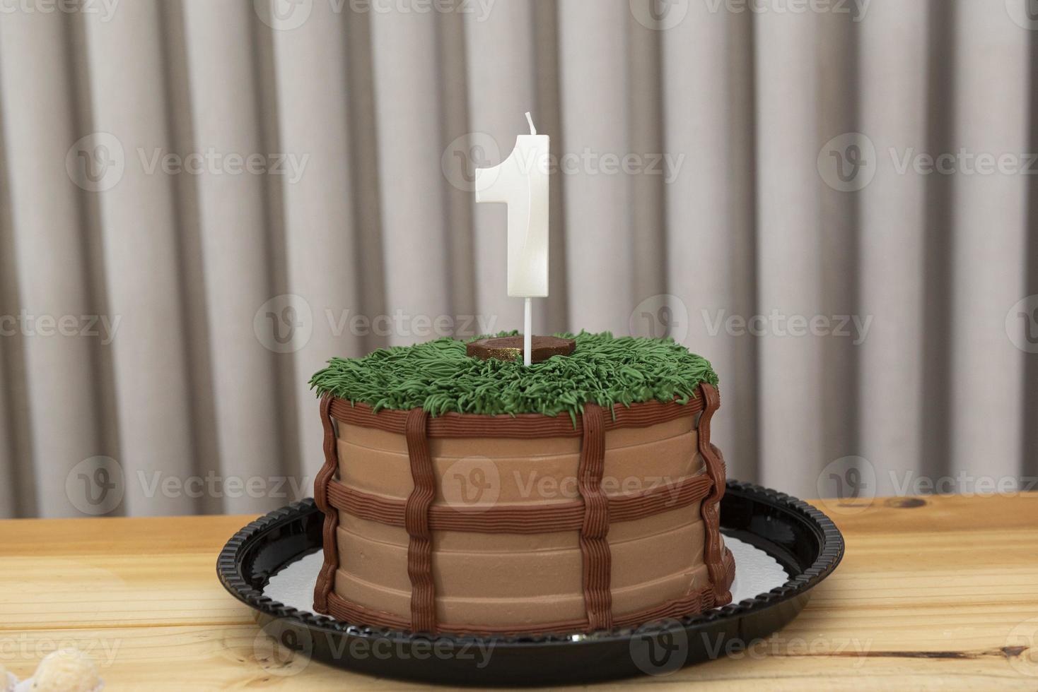 One-year white candle on cake decorated in country theme photo