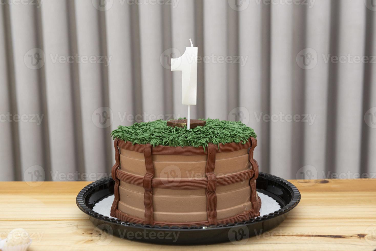 One-year white candle on cake decorated in country theme photo