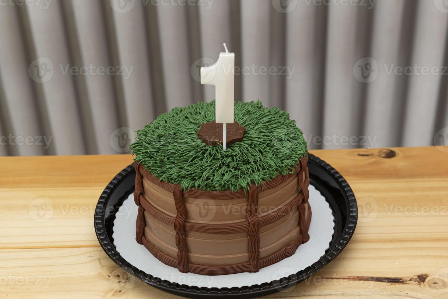 One-year white candle on cake decorated in country theme photo