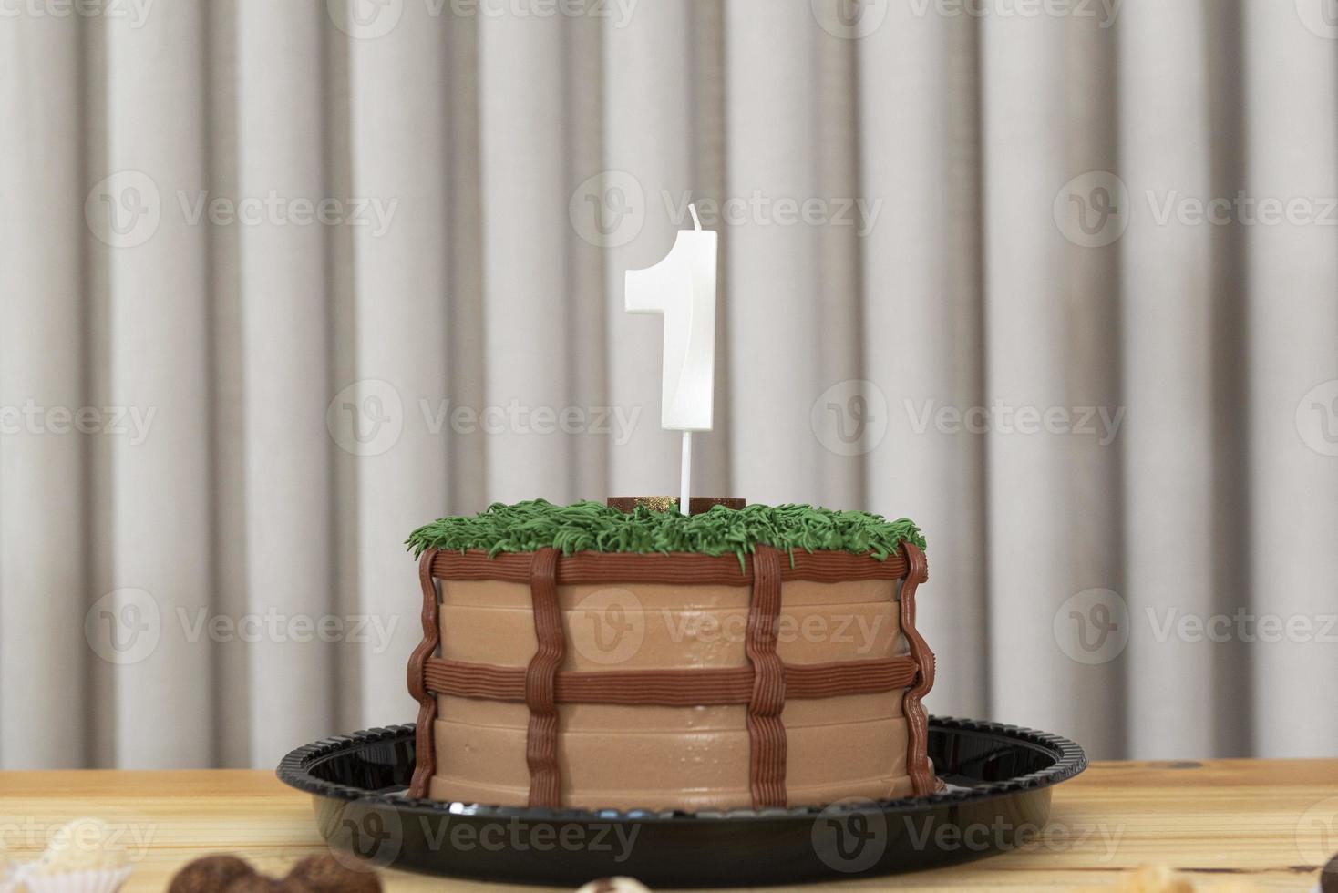 Vela blanca de un año en tarta decorada con temática campestre foto