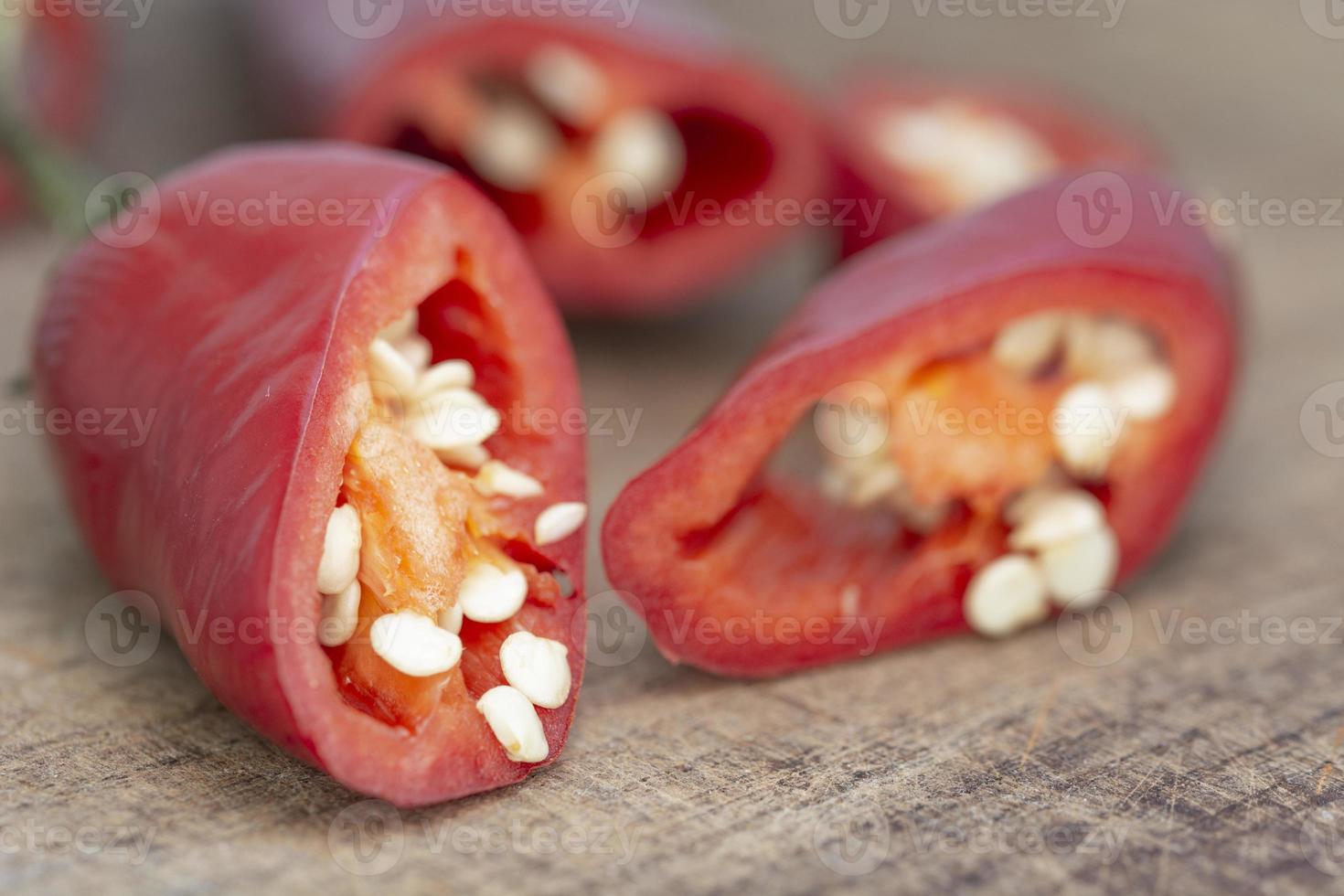 macro shot chile paprika on wooden table photo