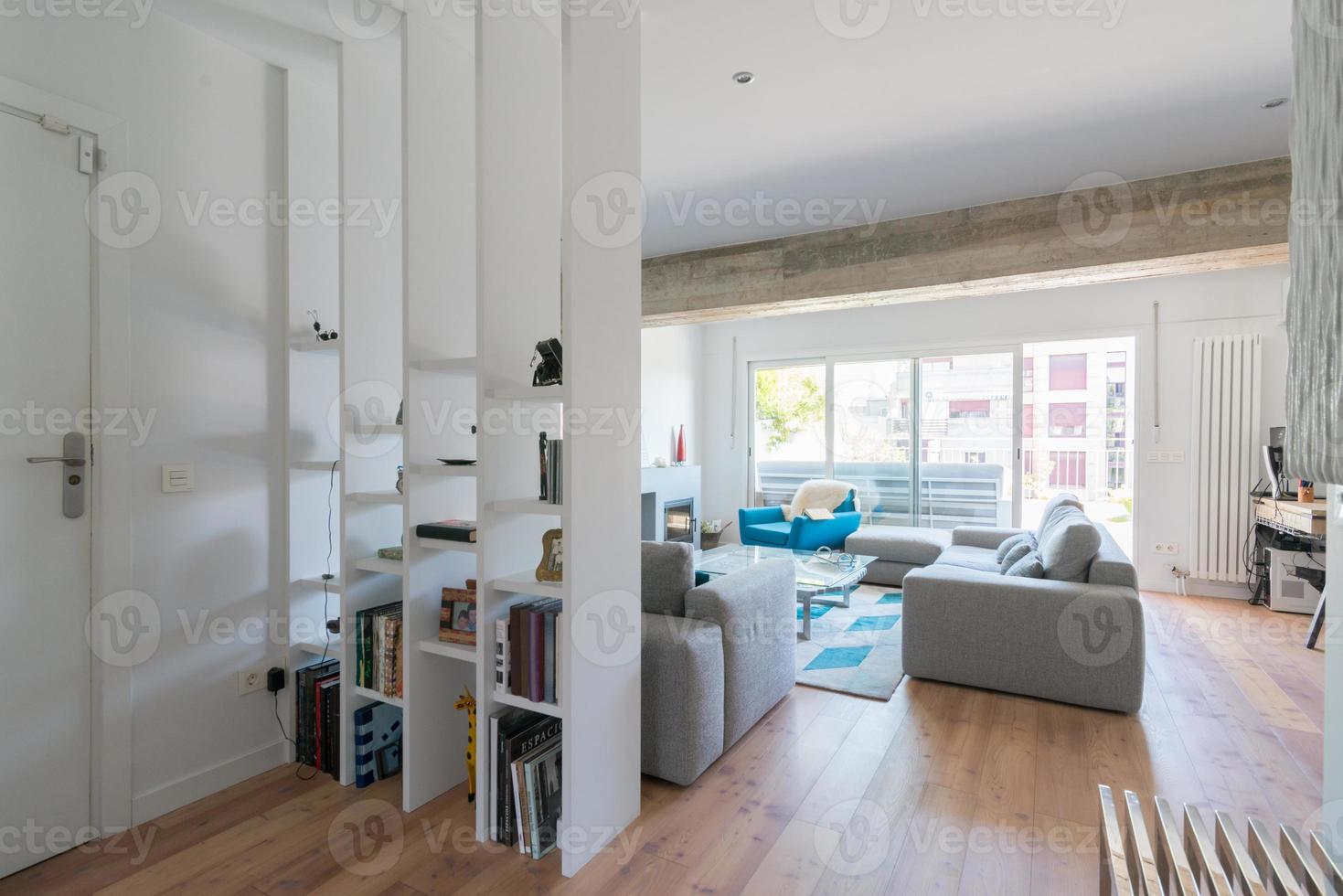 Modern living room with chimney, gray sofas glass door to the terrace. photo