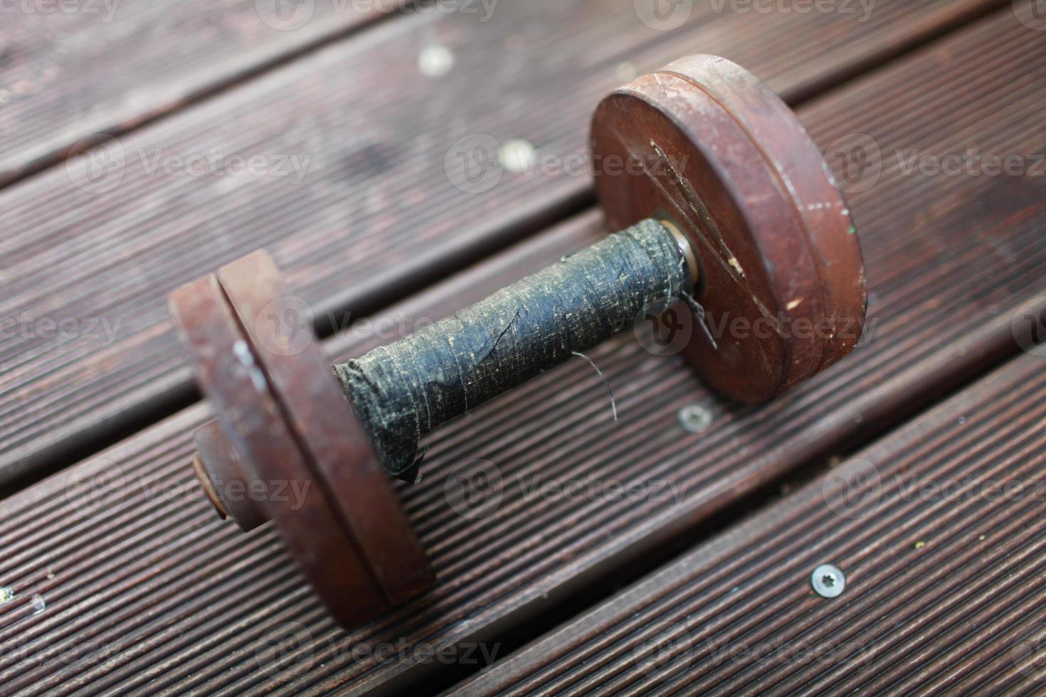 heavy steel dumbbell, handle rewound with black duct tape photo