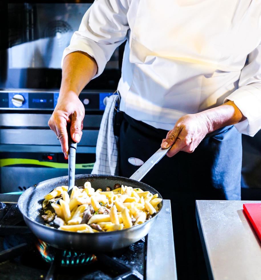 Chef preparing food in the kitchen, chef cooking, closeup photo