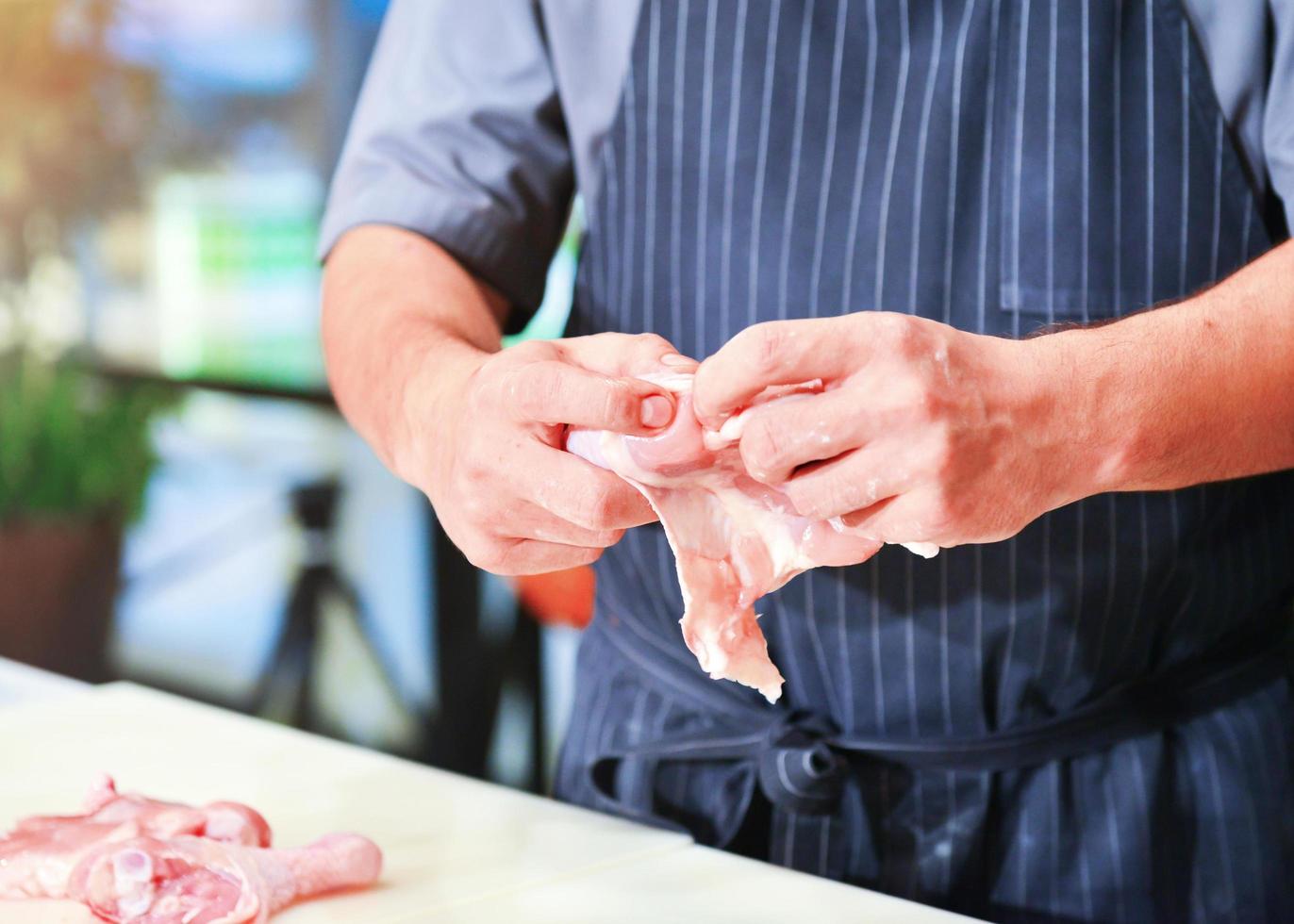 Chef prepared cutting chicken  cooking photo