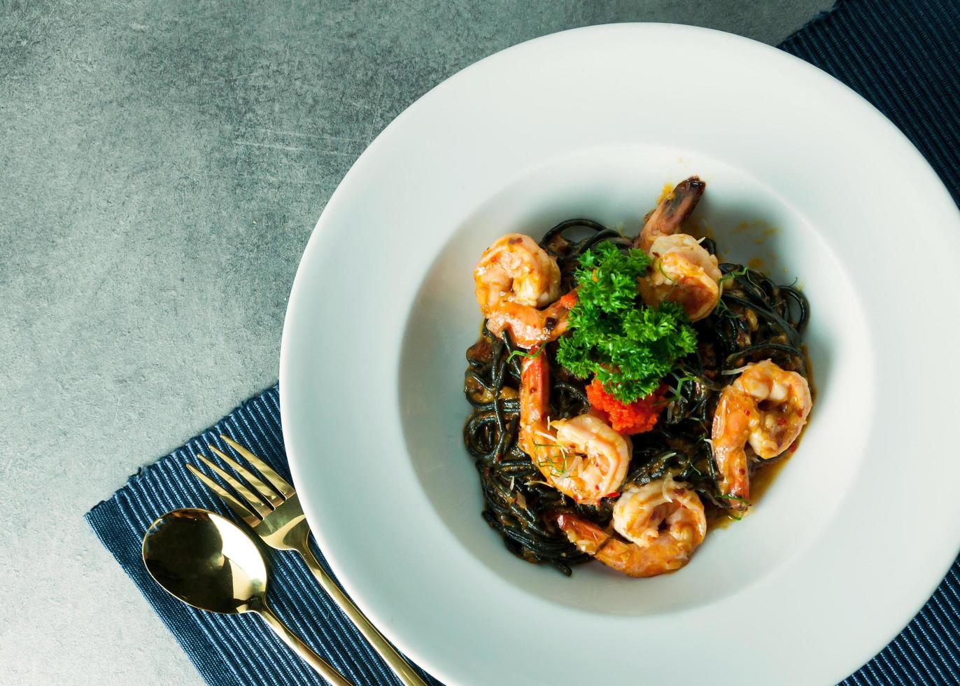 Squid-ink spaghetti with spicy prawn for lunch or dinner photo