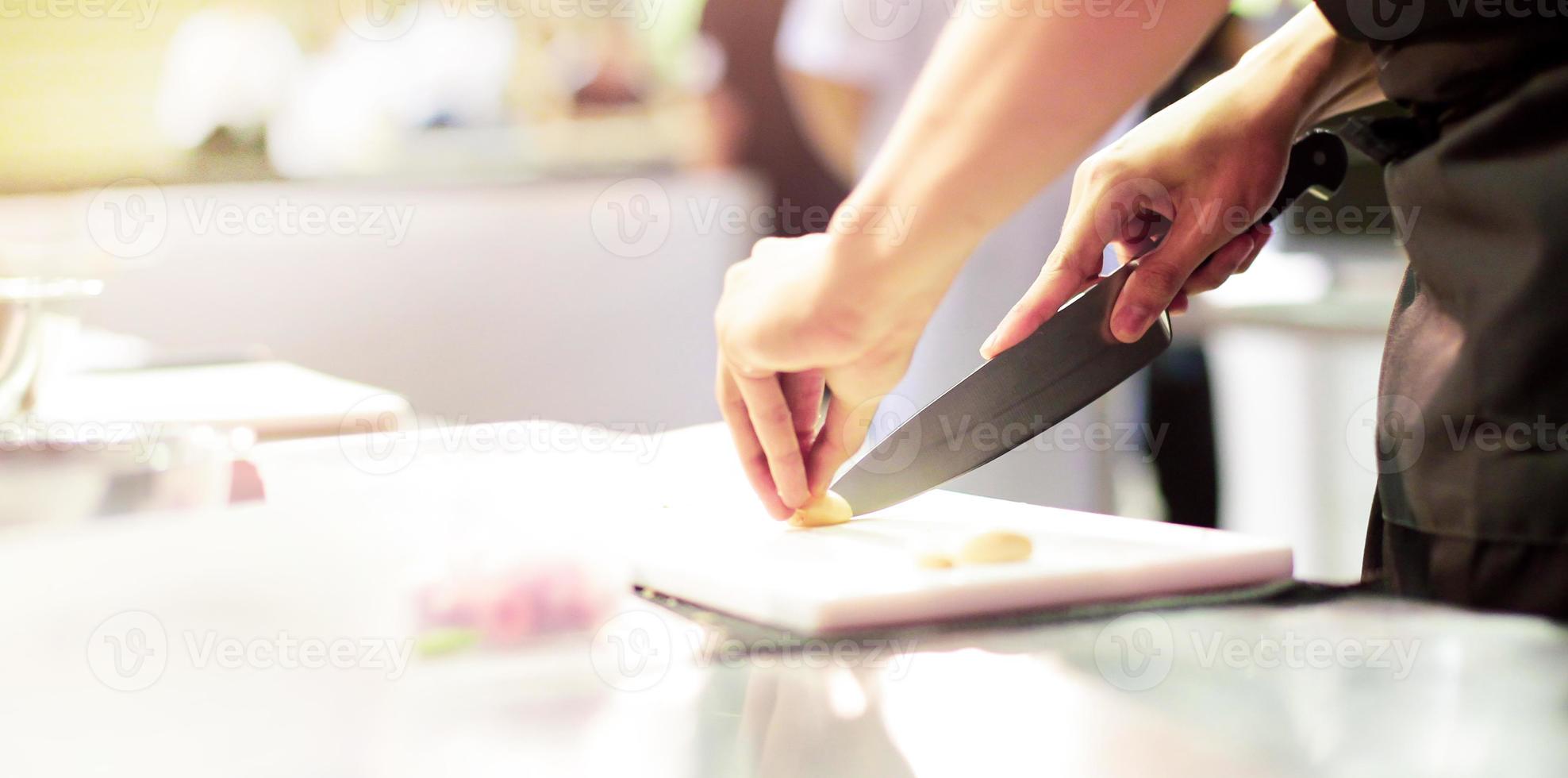 Chef cuts the vegetables cooking in a kitchen photo