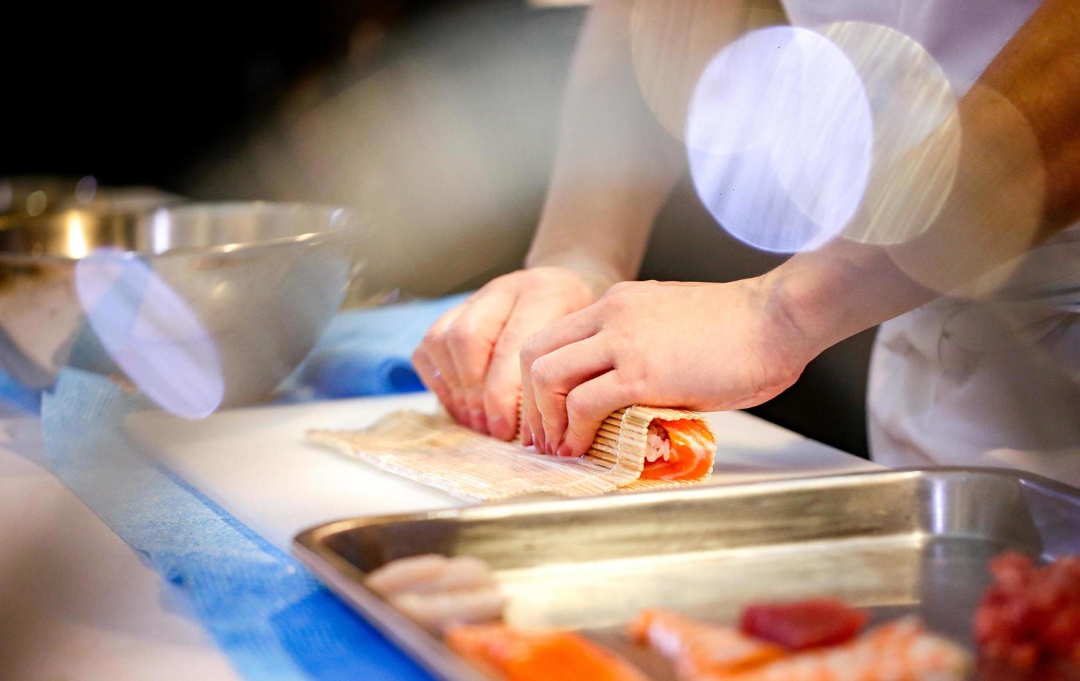 chef hands preparing japanese food, chef making sushi photo