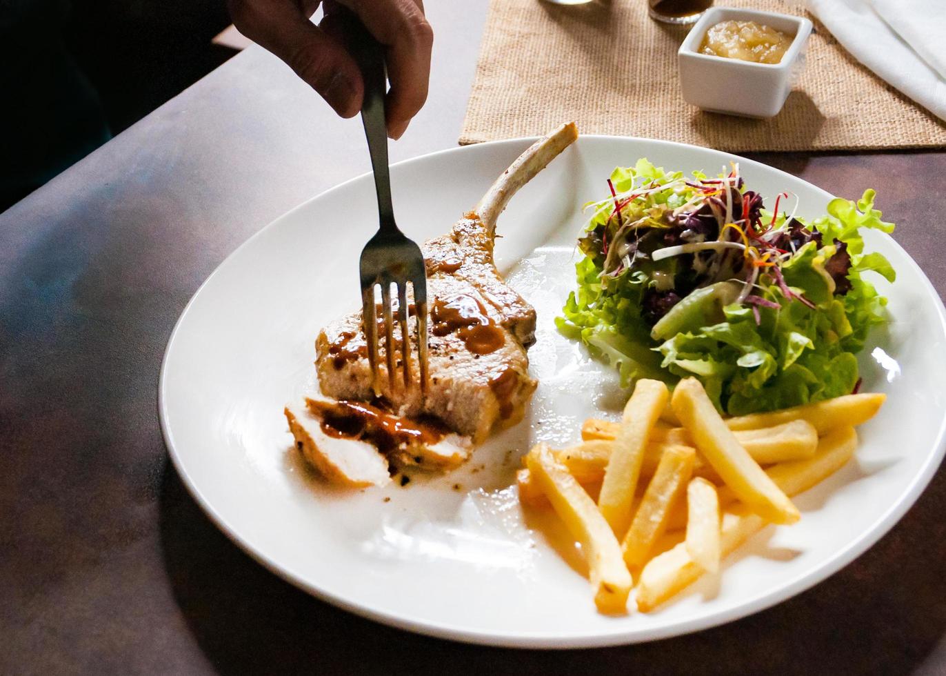 Pork chop steak with salad and french fries photo