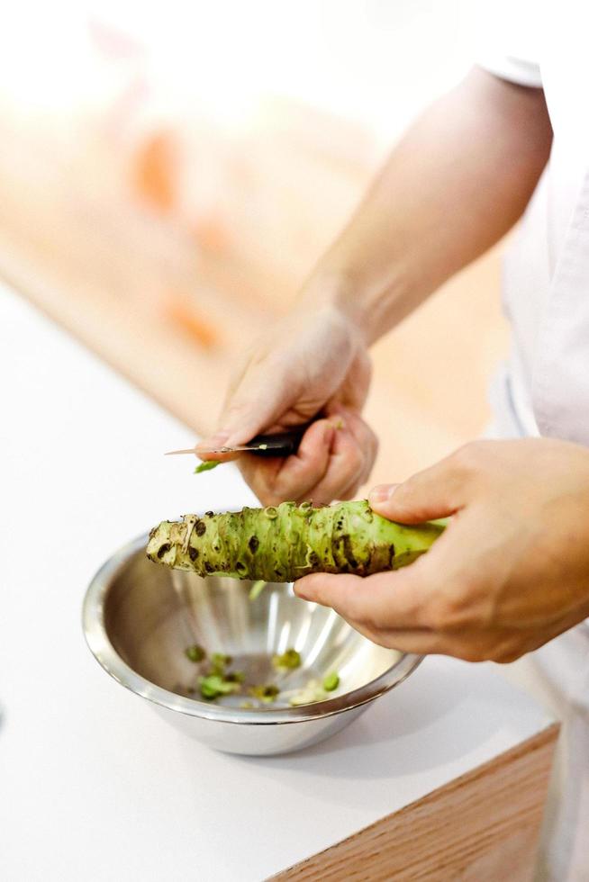 Sushi chef grating fresh Wasabi, Fresh wasabi root photo