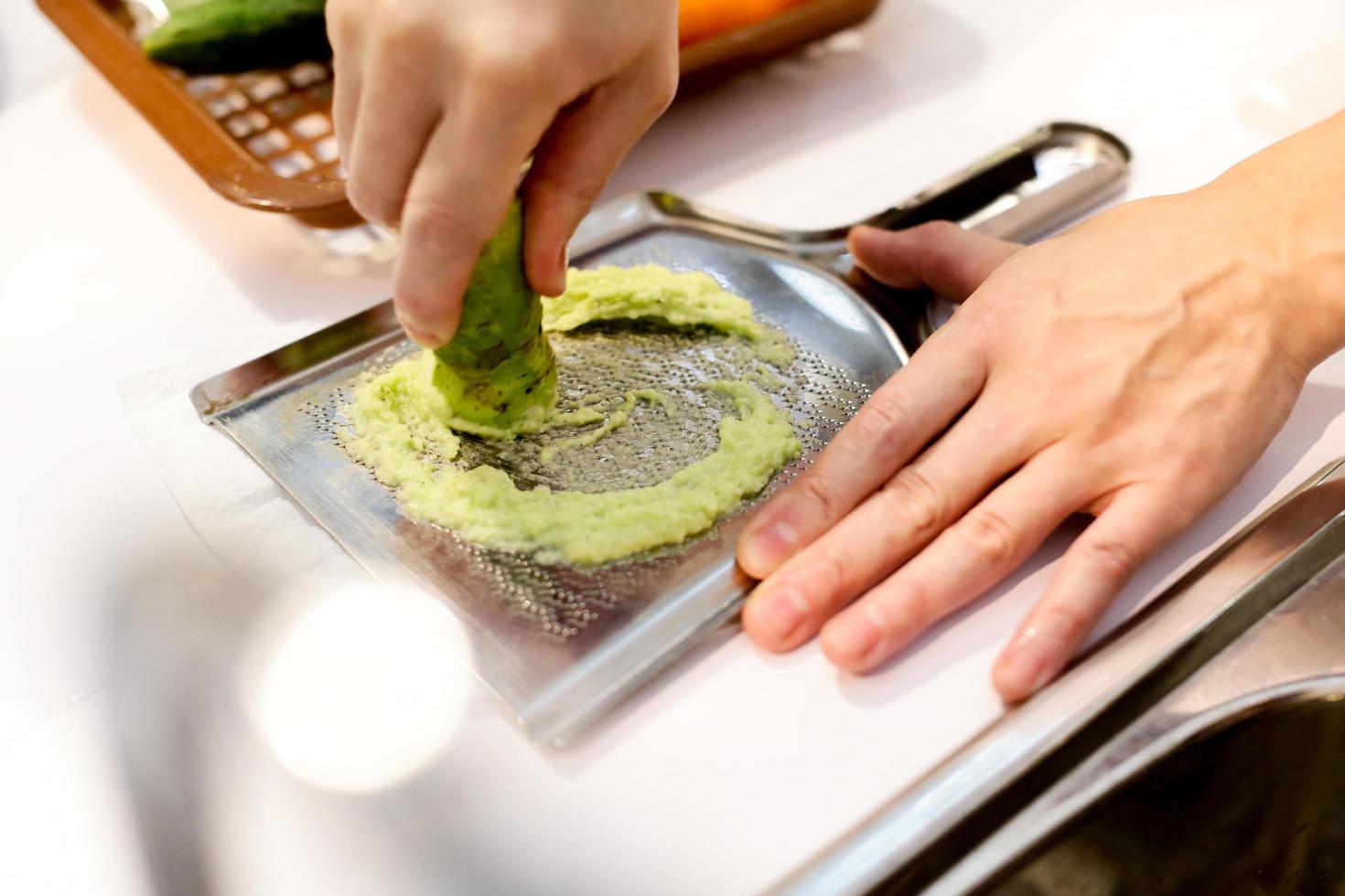 Sushi chef grating fresh Wasabi, Fresh wasabi root photo