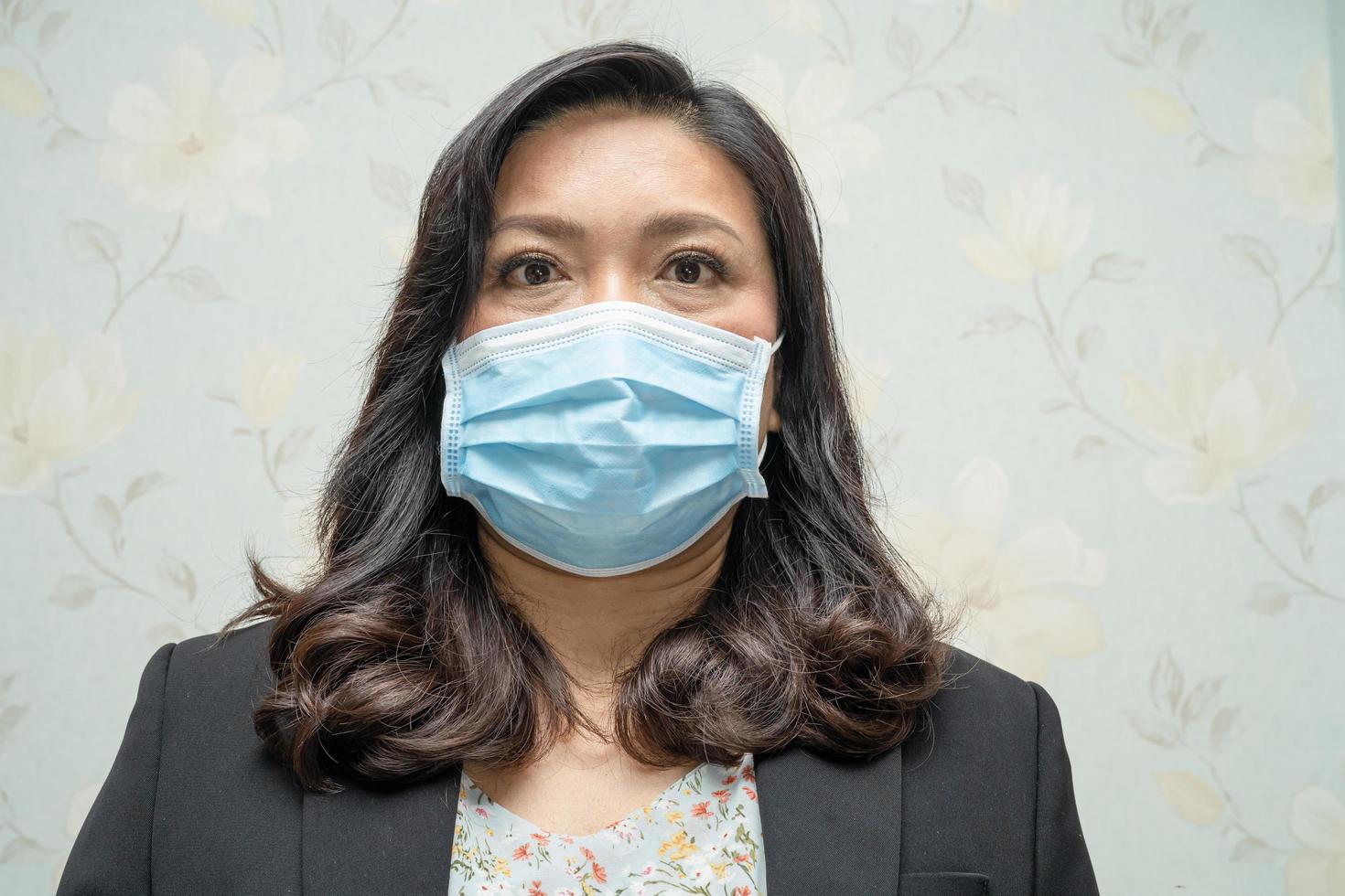 Asian lady wearing mask new normal in office photo