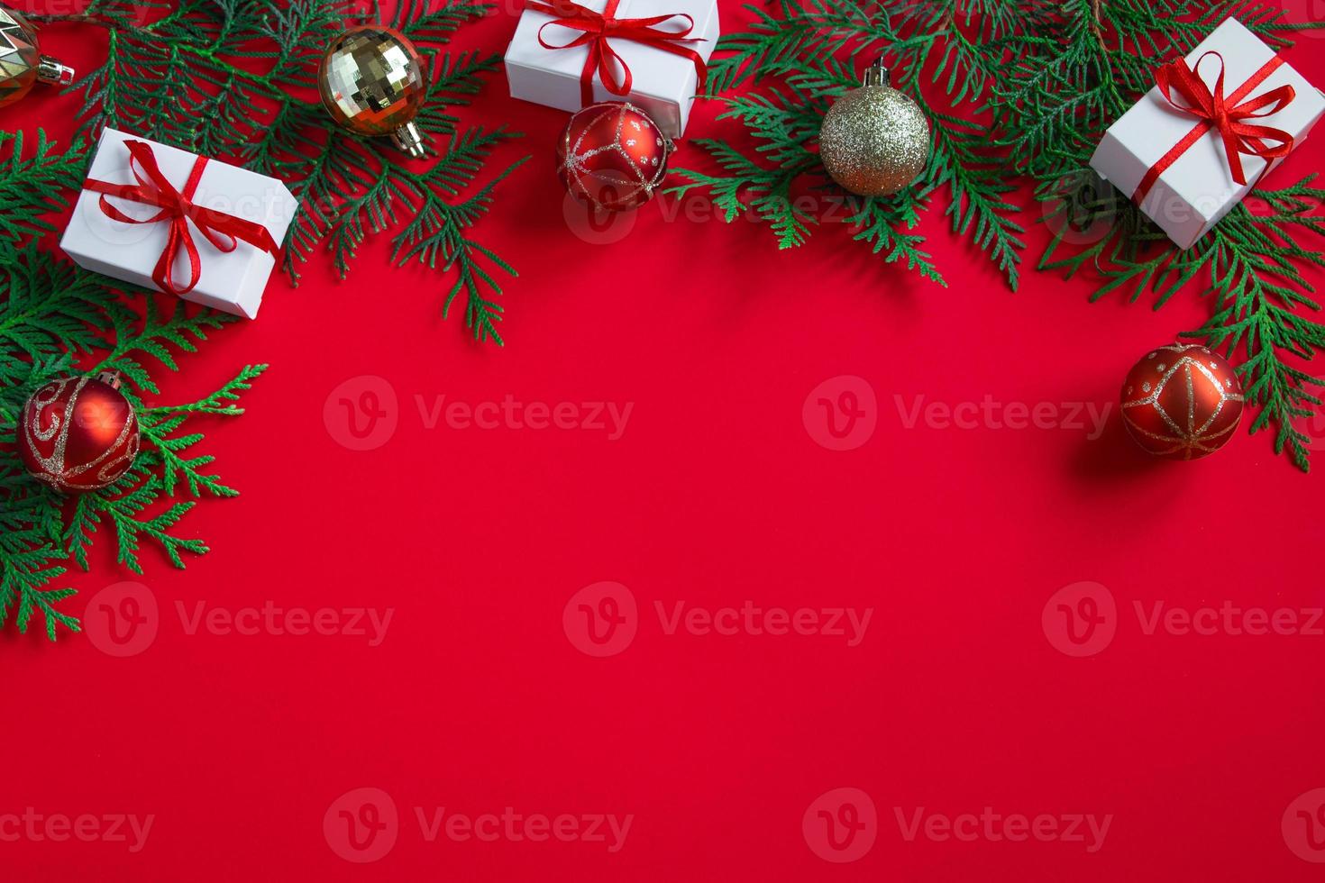Gift boxes and festive decor. Christmas composition on red background. photo