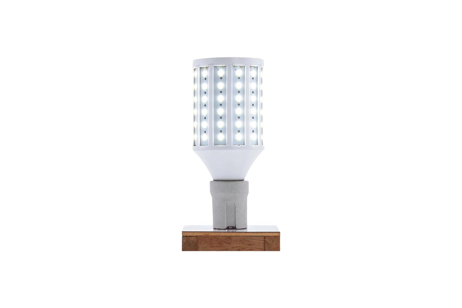 E27 230v screw cap LED energy saving lamp on a wooden base. photo