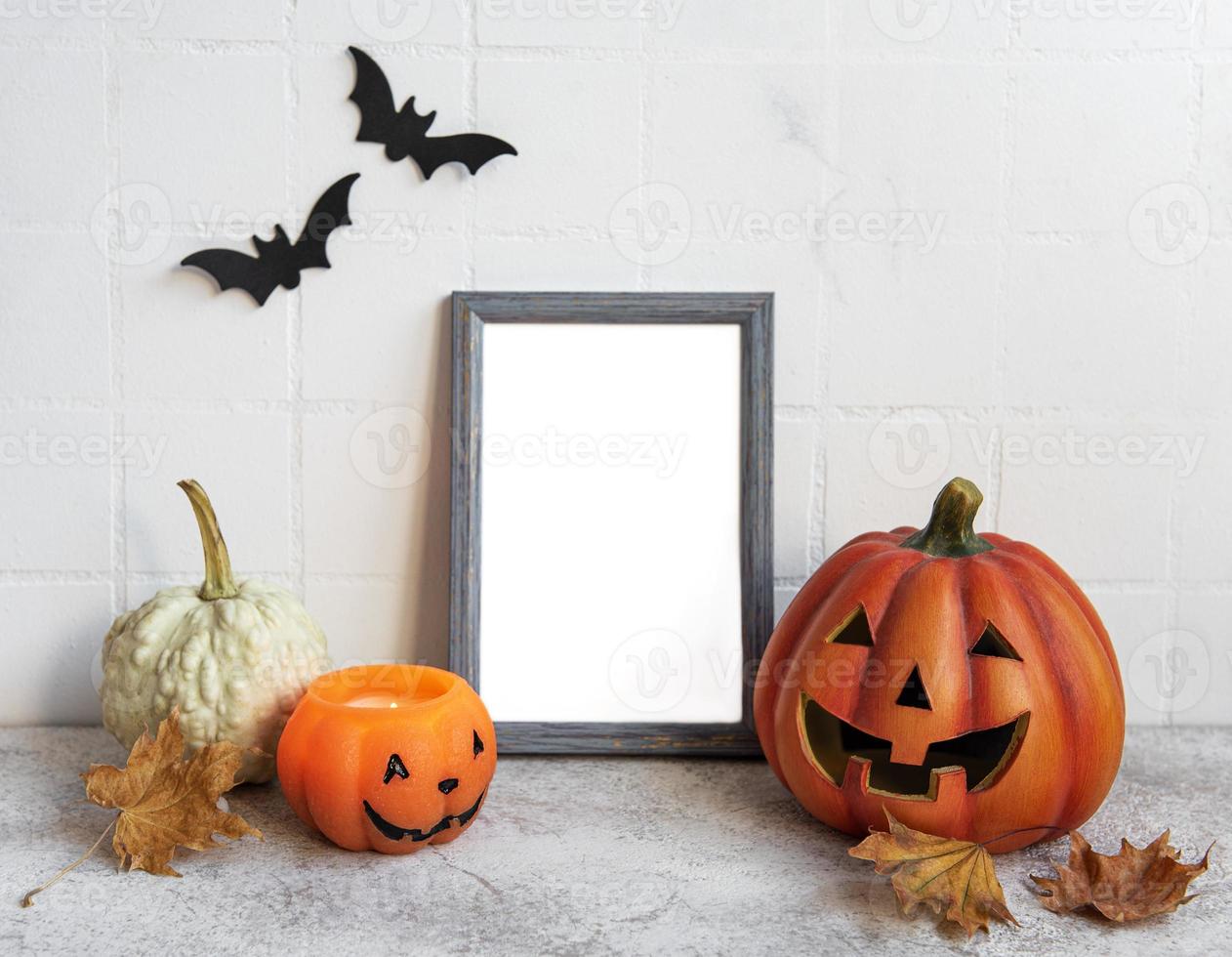 Mock up  frame with Jack o Lantern and pumpkin decor on a table. photo