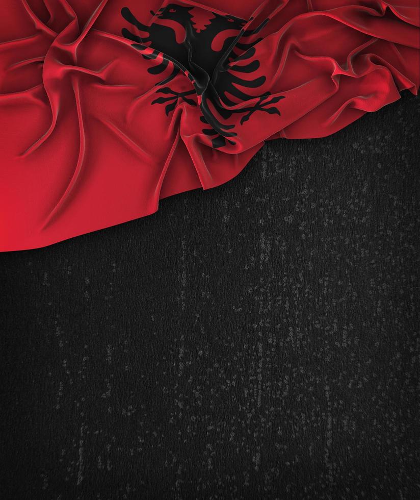 Bandera de Albania vintage en una pizarra negra grunge con espacio para texto foto