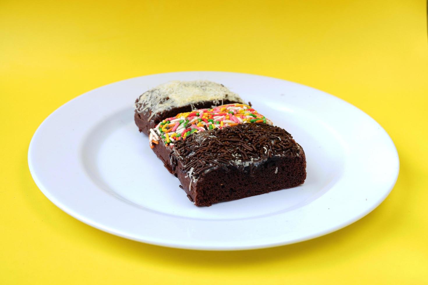 Sponge cake on white plate isolated photo