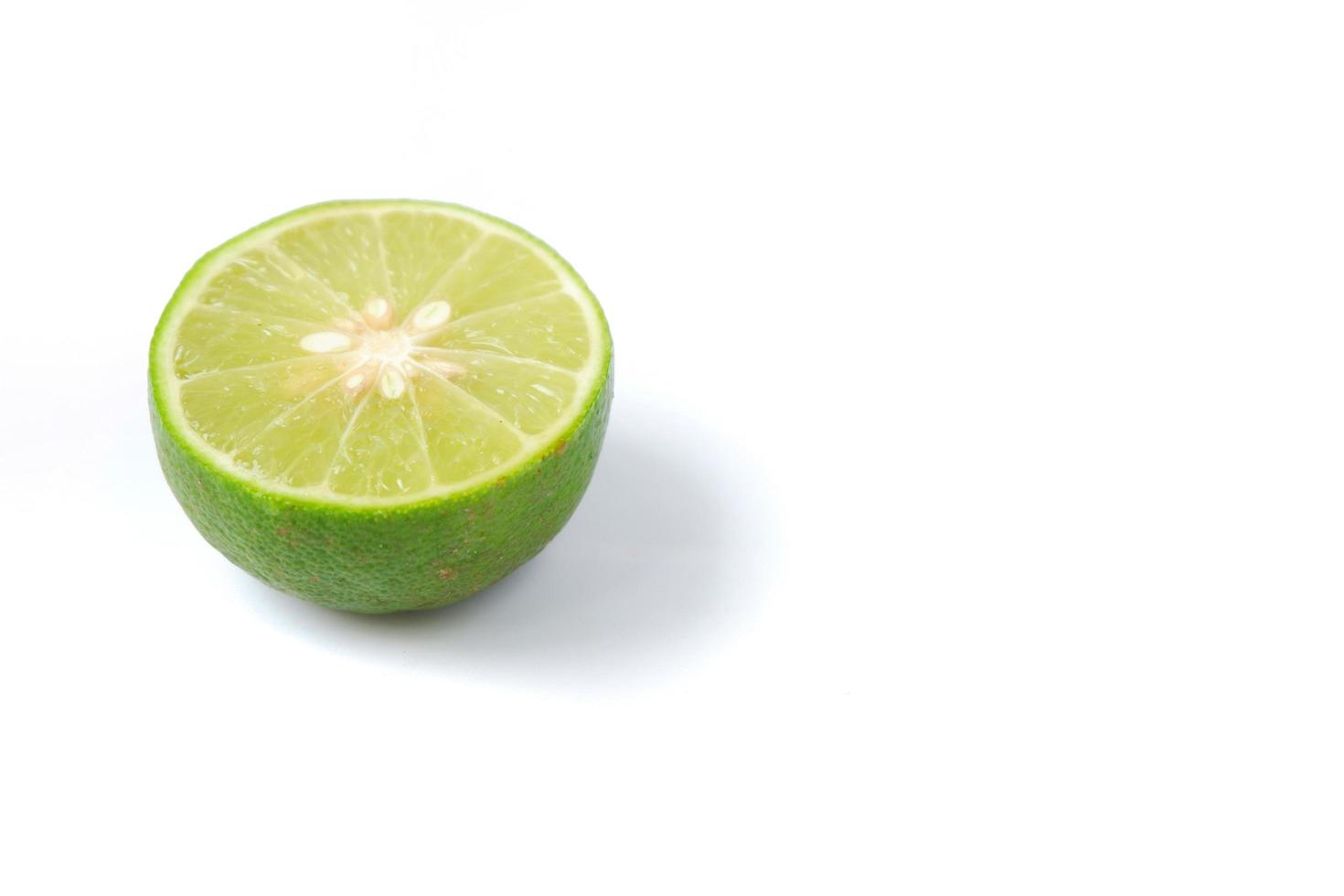 Lime with slices isolated on a white background photo