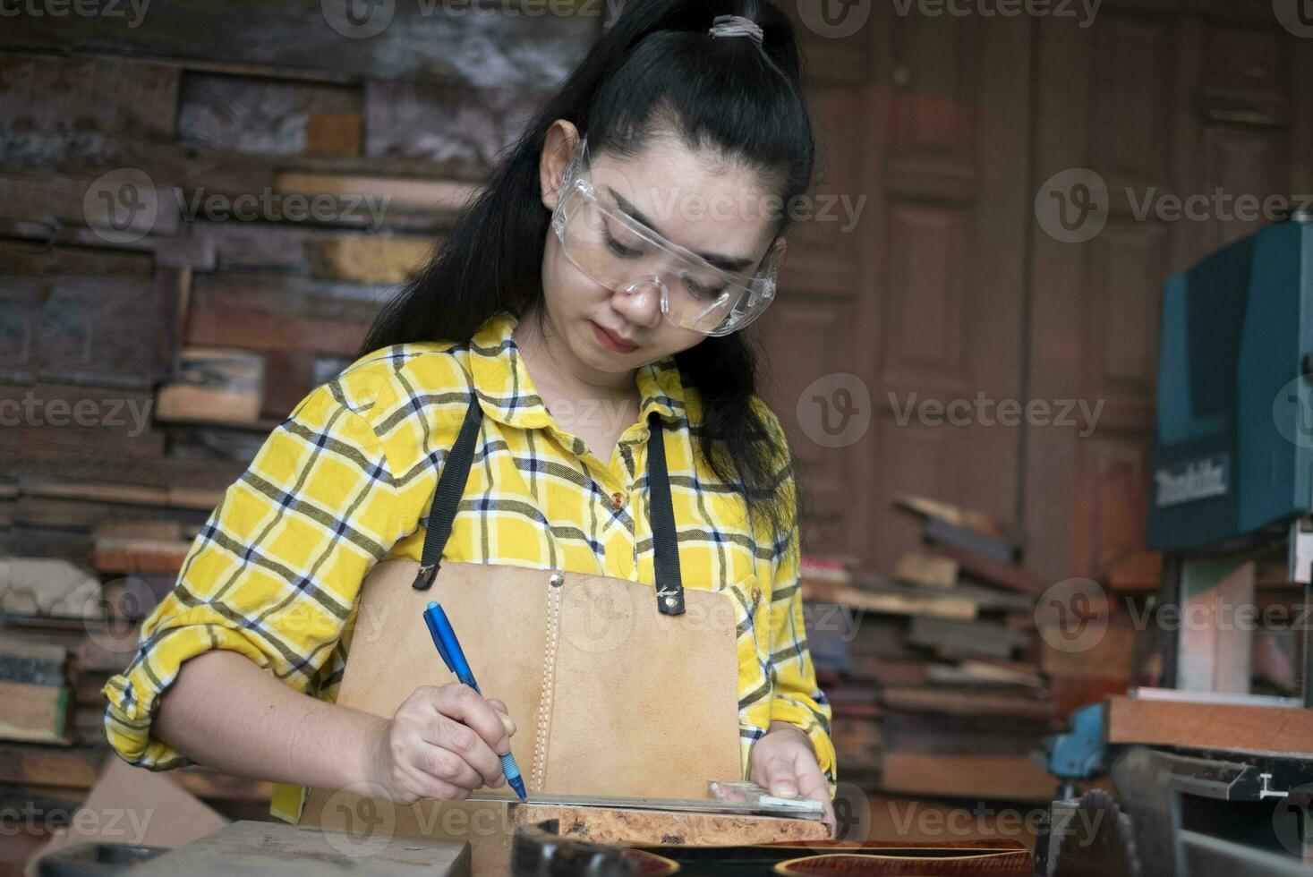 Woman holding ruler and pencil while making marks photo