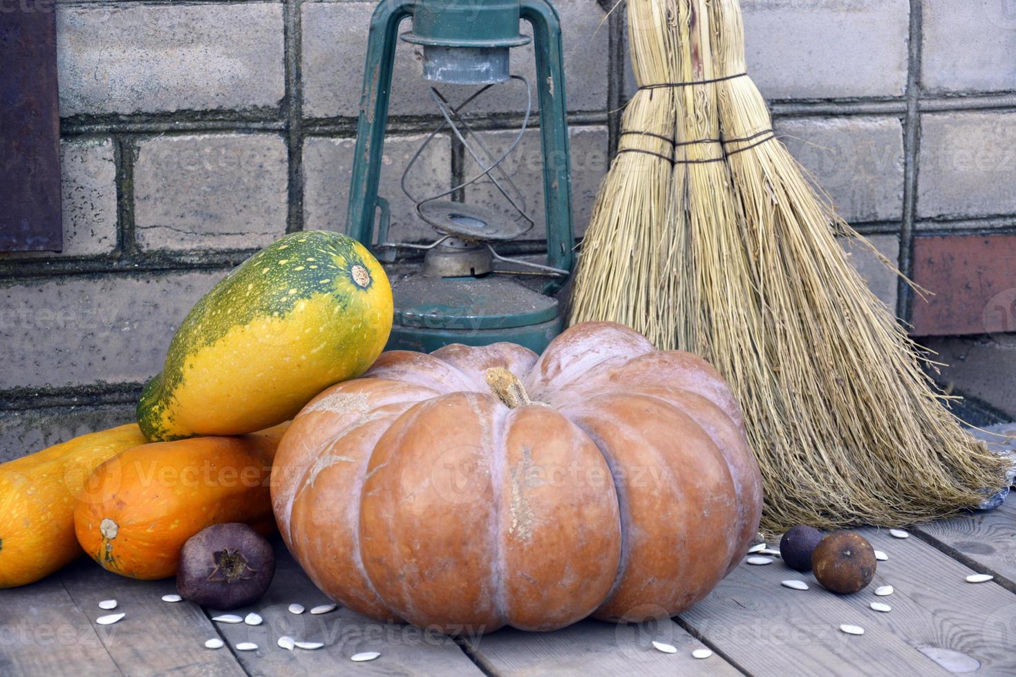 Pumpkin, zucchini on a wooden background next to an old lamp photo