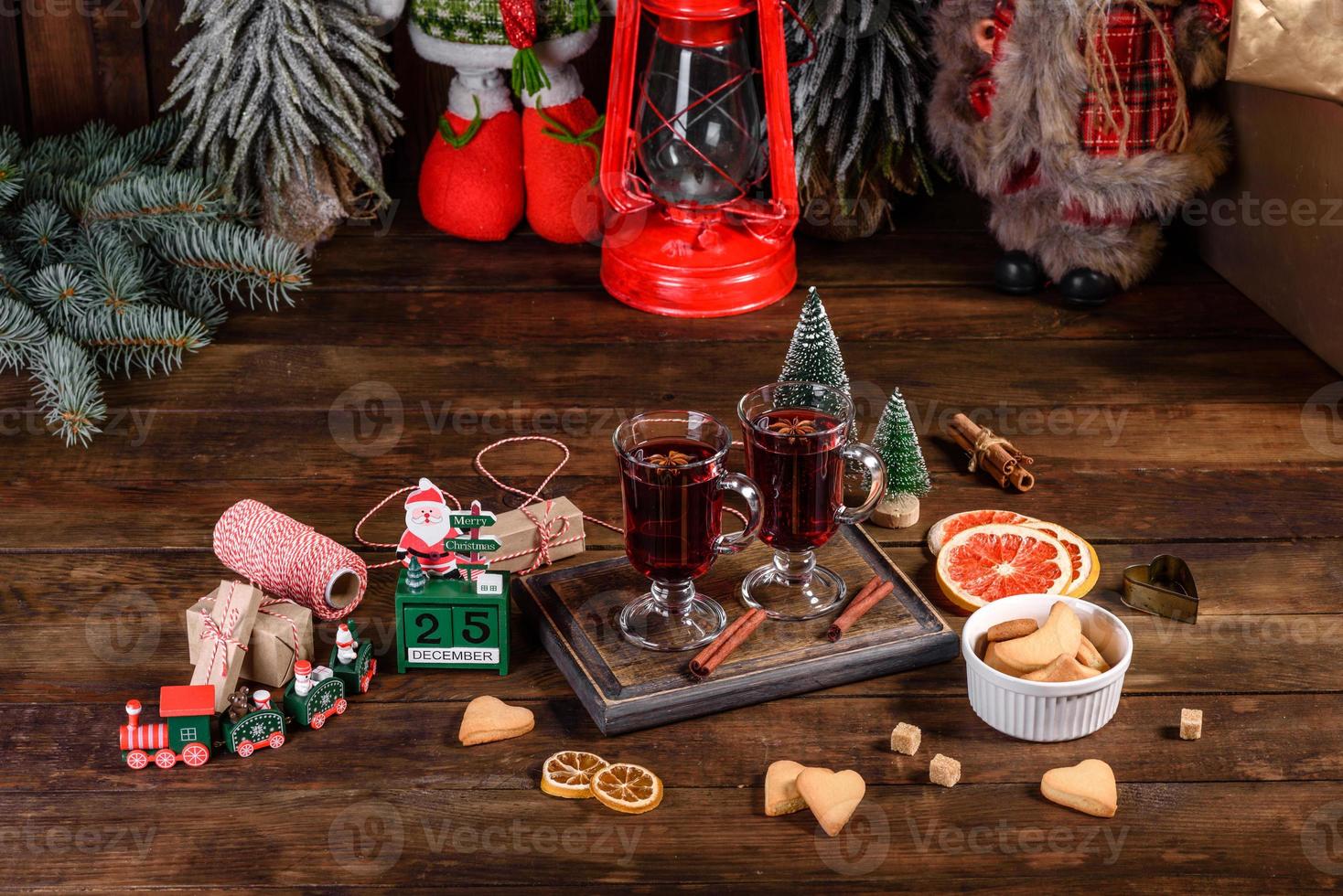 Christmas mulled red wine with spices and fruits on a dark table. photo