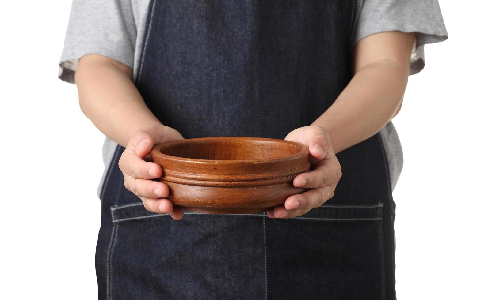 Chef holding wooden cup on white background photo