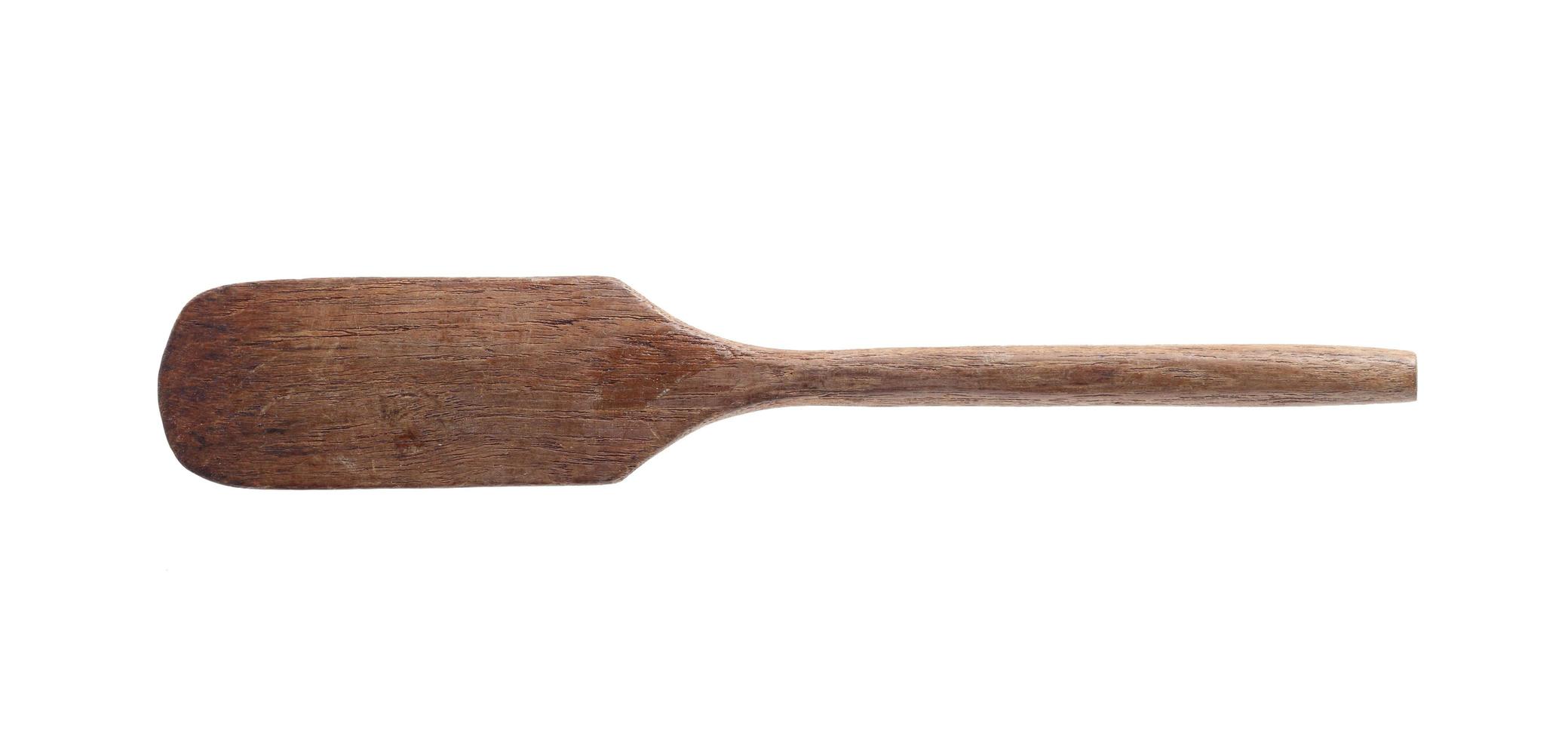 Vintage wooden spatula on white background photo