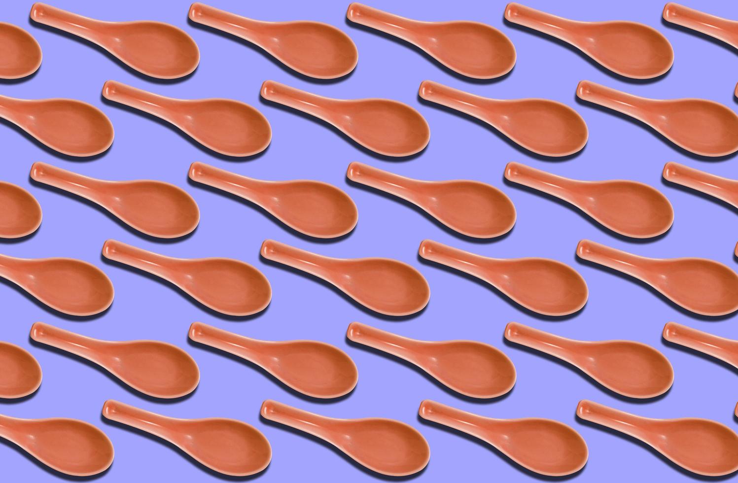 Group of ceramic pastel spoon on pastel background photo