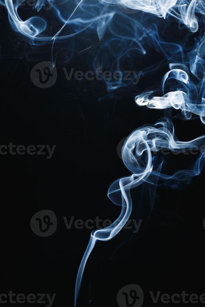 Smoke floating on dark background photo