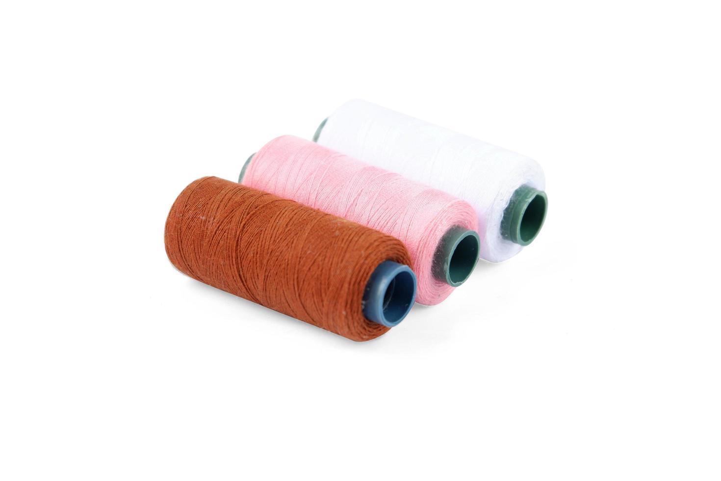 Color sewing thread isolated on a white background photo