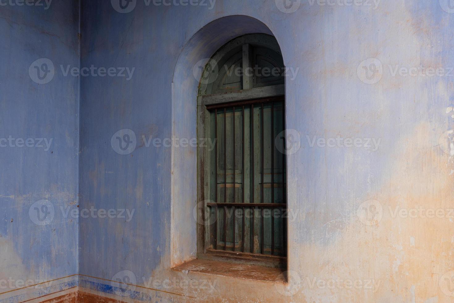 Green window on old retro building photo