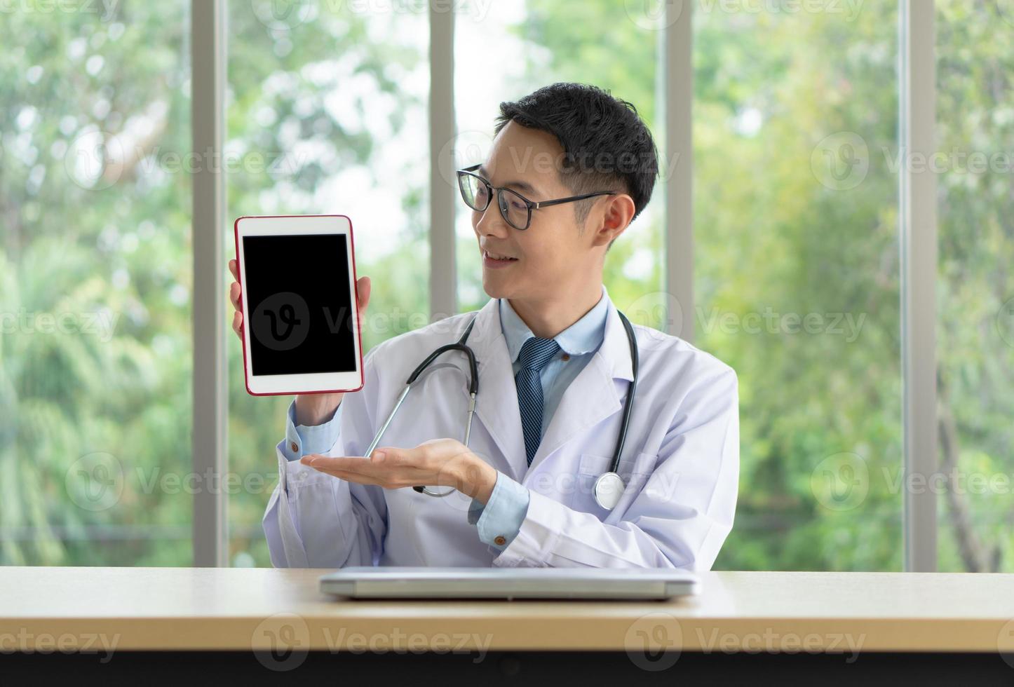 Asian doctor give consult  online photo