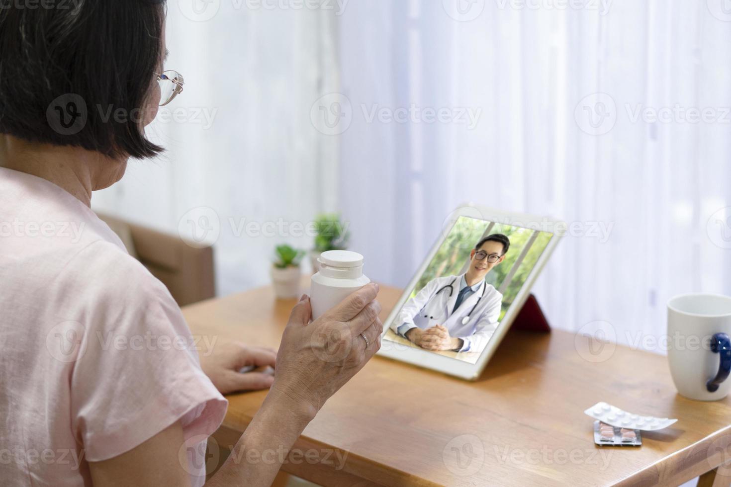 Senior woman consult doctor online via video call photo