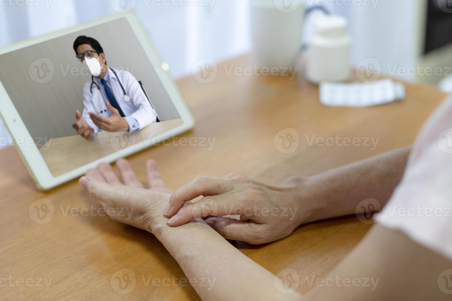 Patient consult asian doctor online via video call photo