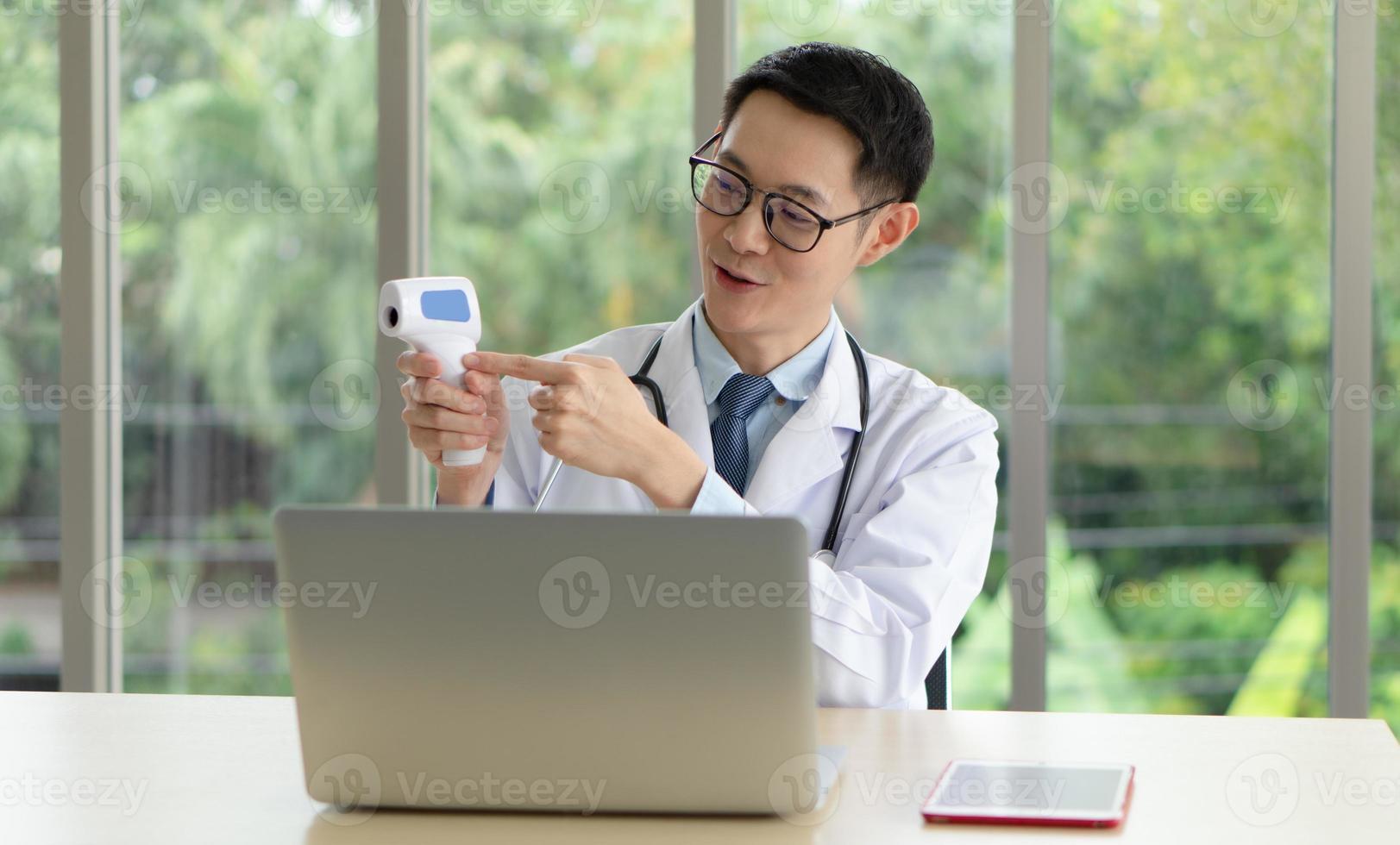 Young Asian doctor give consult to patient online photo