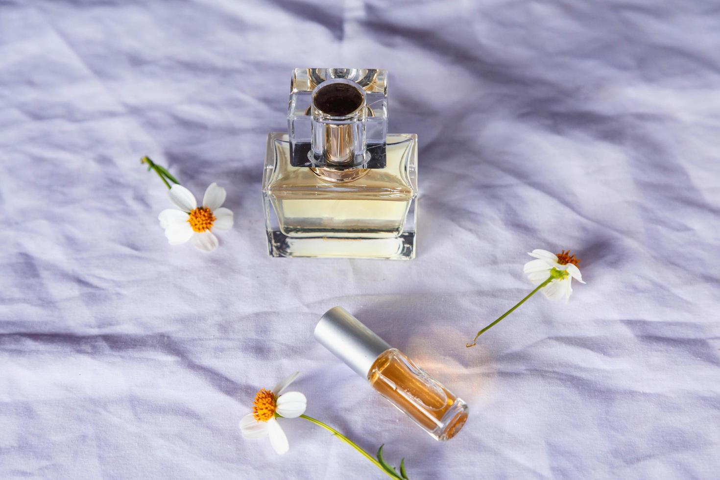 Golden perfume and perfume bottles on white background photo