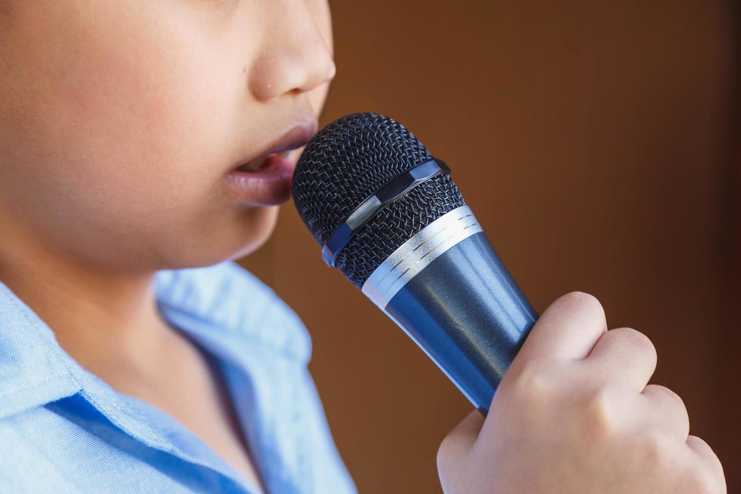 Boys with microphone learn to sing photo